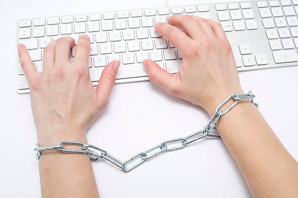 Women's Hands Chained to Keyboard,Censorship. stock photo