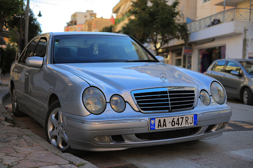 Mercedes-Benz EQE full electric luxury car parked on the side of a country road in nautre during an autumn day. The Mercedes-Benz EQE (V295) is a full electric executive car and one of the models of the Mercedes-Benz EQ family produced by German automobile manufacturer Mercedes-Benz Group.