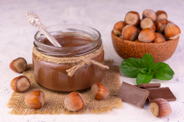 A jar of chocolate spread with hazelnuts.