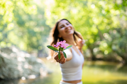 Beautiful Young Woman Holding Flower in Her Hand