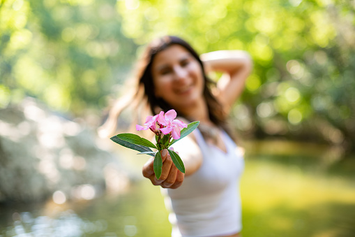 Beautiful Young Woman Holding Flower in Her Hand