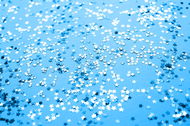 blue sparkles on purple background. Festive backdrop for your projects
