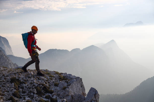 istock Silhouette of a mountain climber on a rock 1397868407