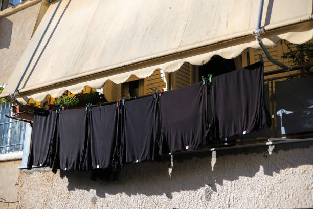 Black T-shirts to dry on the balcony of the house