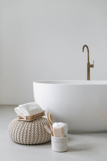 istock Bathtub with towels and bath accessories in bright room 1397869785
