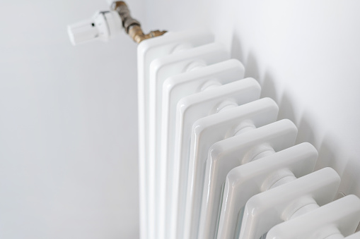 Selective focus on new radiator of the central or individual heating system. Concept of heat supply to residential buildings. Advertising on domestic and household equipment, copy space