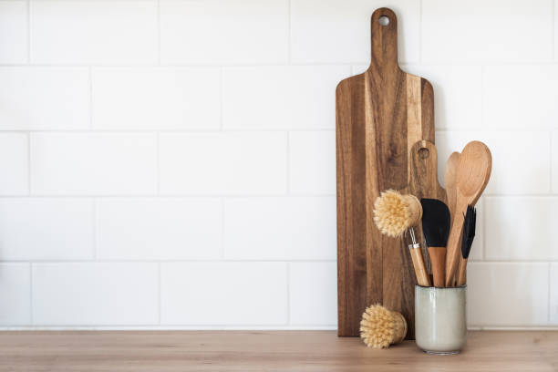istock Wooden cutting board and dishwashing brushes on table 1397870336