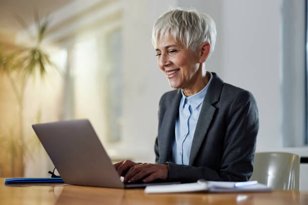 istock Happy mature entrepreneur typing an e-mail on a computer at home office. 1397874038