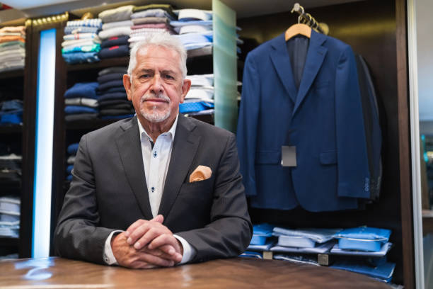 istock Confident senior male owner with hand clasped 1397874727