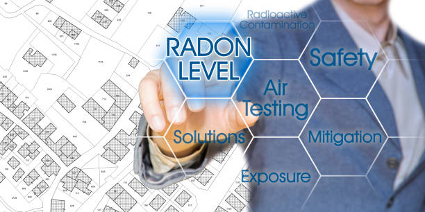 the danger of radon gas in our cities - concept with business manager pointing to icons against a digital display and imaginary city map - radium imagens e fotografias de stock