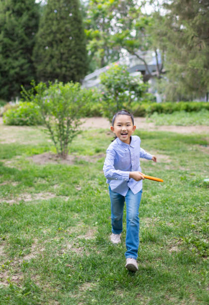 istock Little Girl Playing Frisbee 1397876581