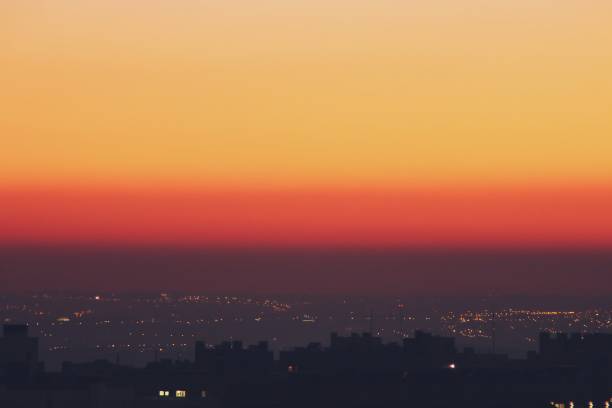 Sunset in warm tones in the skyline of the city of Madrid, Spain. Haze is created by lack of winter wind and photochemical smog from heating buildings and car exhausts. heat haze stock pictures, royalty-free photos & images