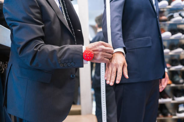 istock Senior male tailor measuring customer with tape 1397879306