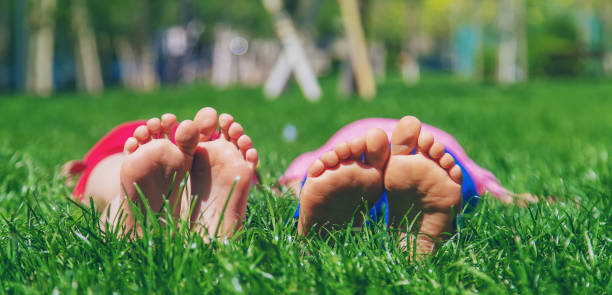 istock Children's feet on the grass. Selective focus. 1397879492