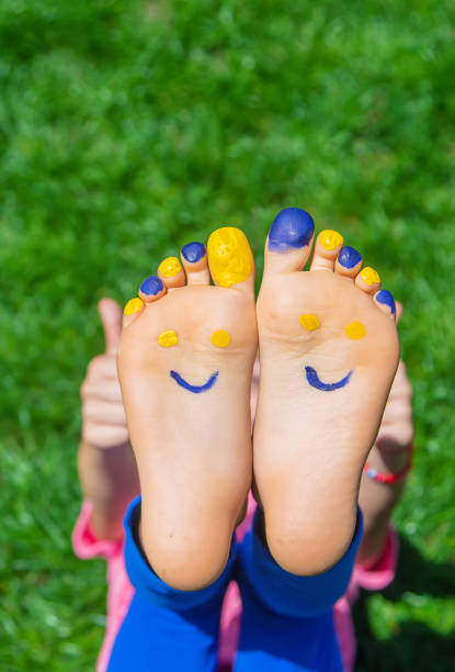 Feet of toddler among flowers