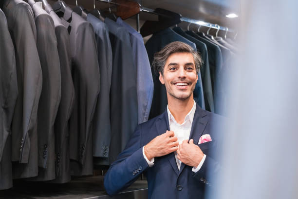 istock Smiling handsome man trying suit at clothing store 1397881706