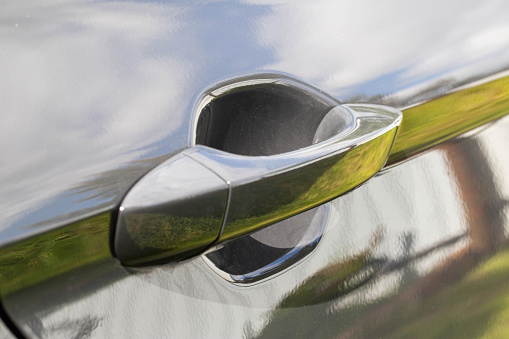 Modern car door handle in gray. Close-up