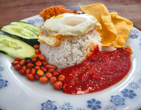 Nasi lemak is a Malay cuisine dish originating from Malaysia that consists of fragrant rice cooked. It is also the native dish in neighboring areas with significant Malay populations such as Singapore, Brunei, and Southern Thailand.