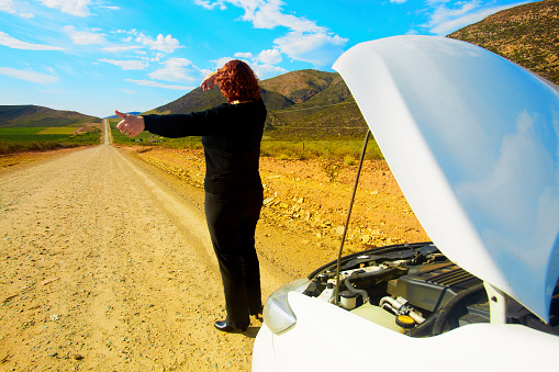 A woman driver’s car breakdown in a rural area