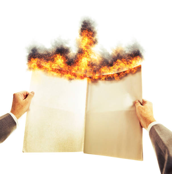 istock Businessman's hands hold a blank burning newspaper with space for copy 1397885403