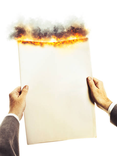 Businessman's hands hold a blank burning newspaper with space for copy