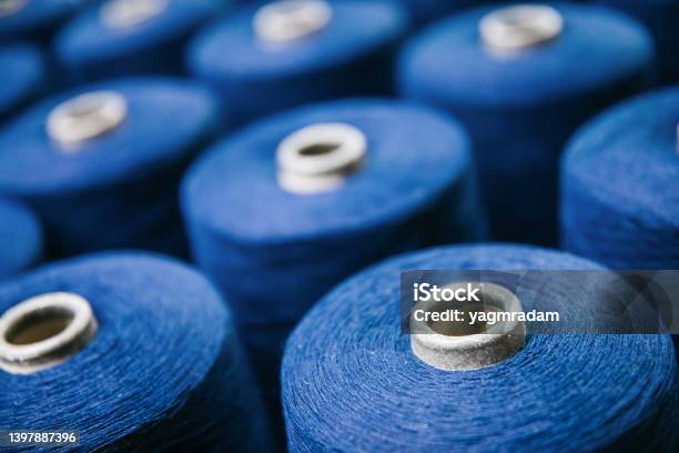 Blue Cotton Yarns Or Threads On Spool Tube Bobbins At Cotton Yarn Factory Stock Photo - Download Image Now