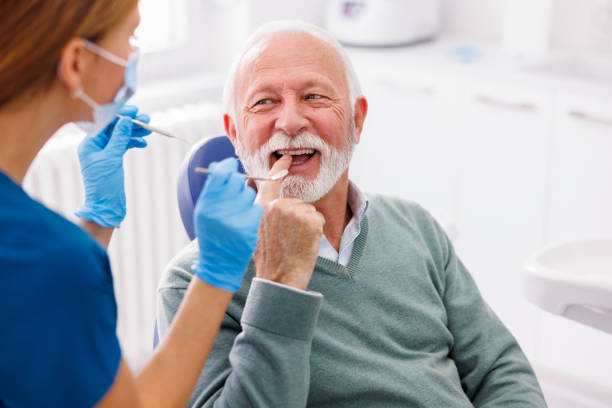 Senior man at dentist check up stock photo