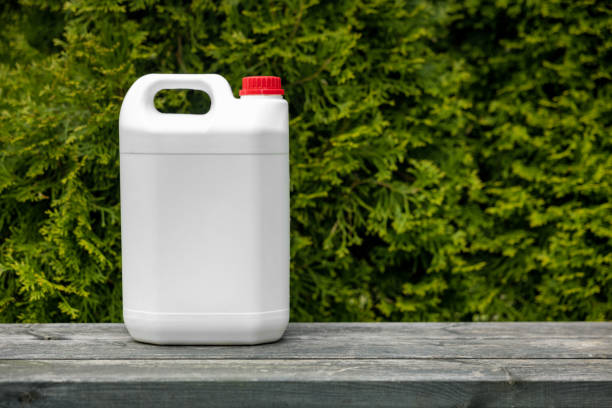 istock white blank plastic fertilizer jerry can for conifer garden plants. copy space 1397888087