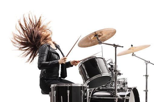 Female drummer playing drums isolated on white background