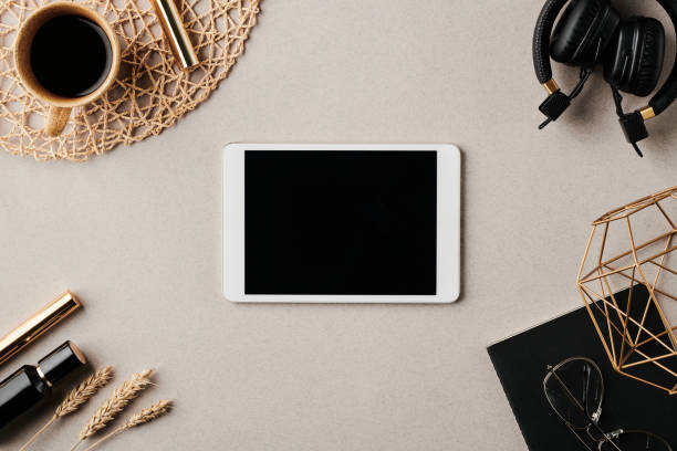istock Tablet with black screen surrounded by headphones, copybook and other objects 1397888883