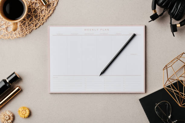 istock Flatlay of planner with pencil surrounded by cup of coffee and other objects 1397888891