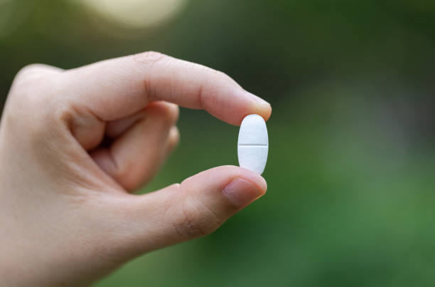 A man holds flu and cold pills in his hand. Treatment of acute respiratory diseases.