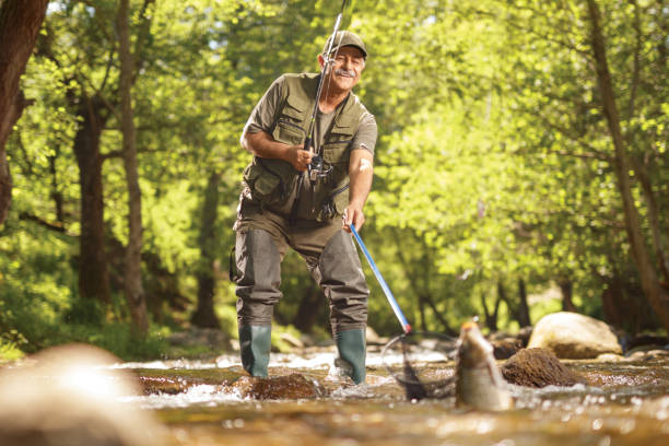 istock Fisherman catching a big carp fish in a river in the woods 1397889146
