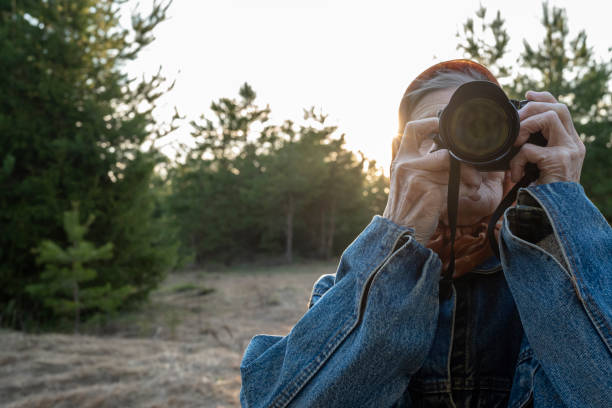 istock Pensioner with a photo camera 1397889248