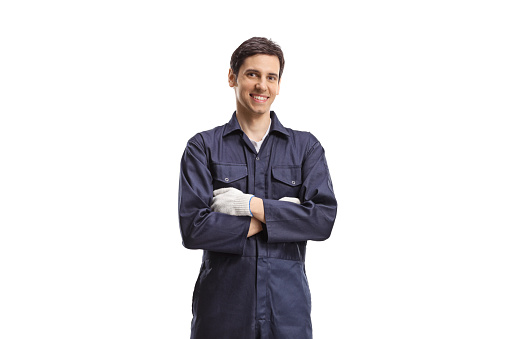 Smiling male worker in a uniform posing with crossed arms isolated on white background