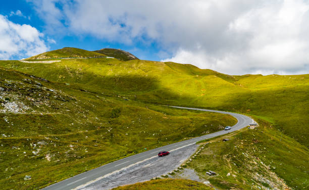 istock Mountains and green meadows on the blue and cloudy sky background. 1397891535