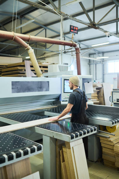 istock Worker standing at machine at factory 1397893290