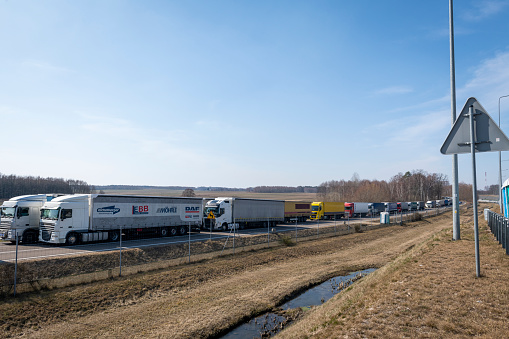 A long line of trucks are parked on the Polish side of the Korczowa - Krakovets border crossing, waiting to cross into Ukraine, on March 20, 2022