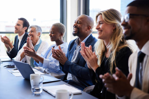 istock Diverse businesspeople smiling and clapping after a boardroom presentation 1397896643