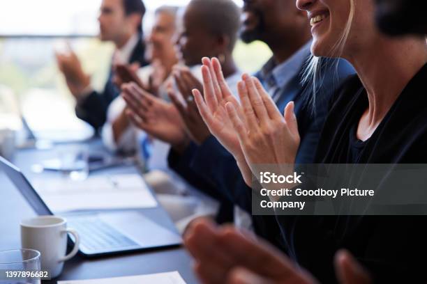 Diverse Businesspeople Sitting Together At A Boardroom Table And Clapping Stock Photo - Download Image Now