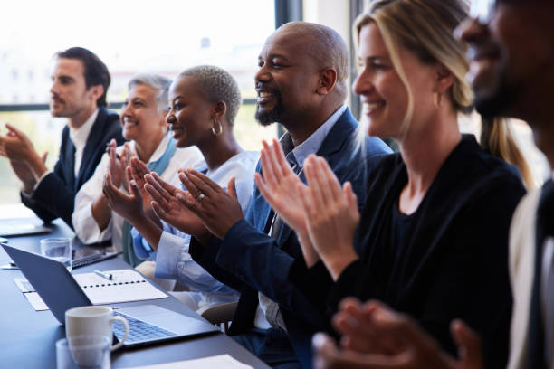 istock Diverse group of smiling businesspeople clapping in a boardroom after a presentation 1397896817