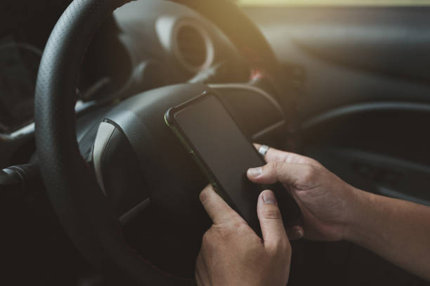 istock Young man driving car and using mobile phone 1397899829