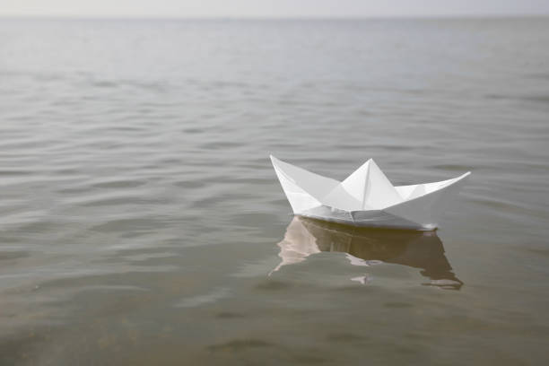istock White paper boat on water surface, space for text 1397902450