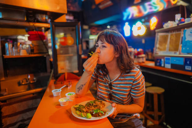 Woman eating taco in a bar