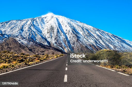 istock Rock formation Roque Cinchado , part of Roques de Garcia, in Teide National Park, Tenerife, Canary Islands, Spain. Snow covered Pico del Teide in the background. 1397904686