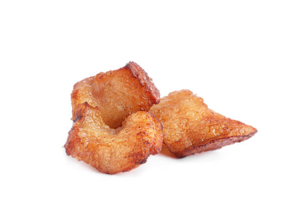 istock Tasty fried cracklings on white background. Cooked pork lard 1397906305