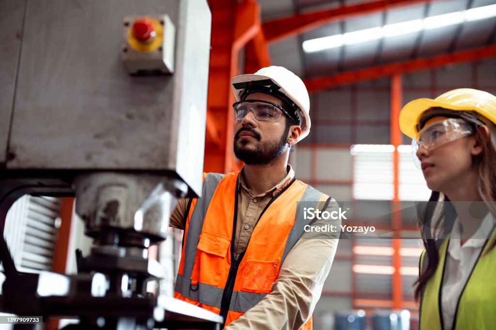Two maintenance engineers men and women inspect relay protection system. They work a heavy industry manufacturing factory. Agricultural Field Stock Photo