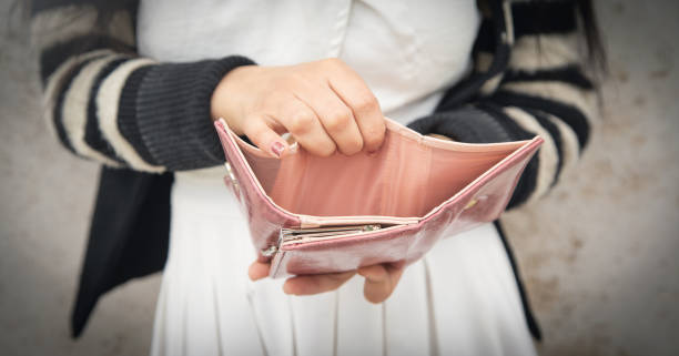 istock Young woman holding empty wallet. No Money 1397911752