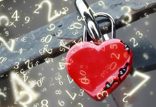 Two red heart shape padlock on a wooden shelf against blue wall with copy space.