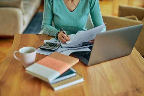 istock Woman going over her finances at home 1397912271